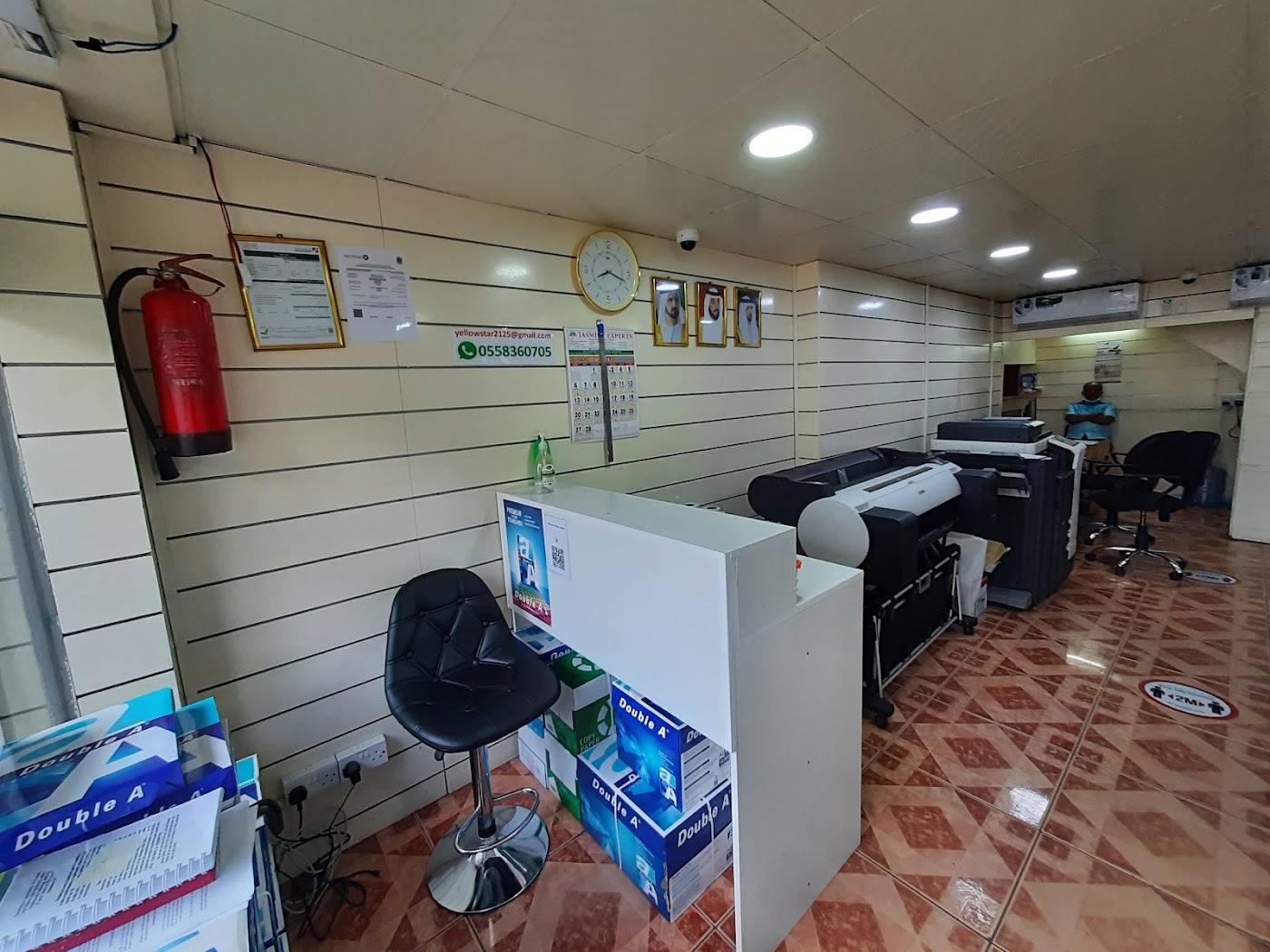 Inside Yellow Star Advertising: wide-format printers and a design desk